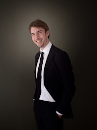 a man in a suit and tie posing for a photo